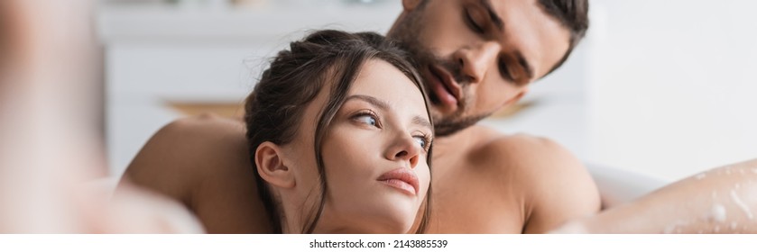 Sexy Man Looking At Brunette Girlfriend While Taking Bath Together At Home, Banner