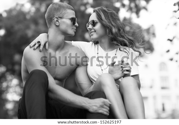 Sexy\
man and woman doing a fashion photo shoot in \
sunset
