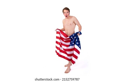 Sexy man wrapped in an American flag. Brutal topless guy on a white background. Isolate. USA Freedom Day.