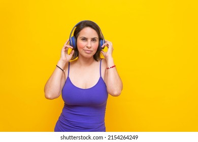 Sexy Middle Aged Mexican Woman Wearing Headphones Looking At Camera Smiling