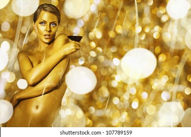 sexy naked golden woman with the glass of wine