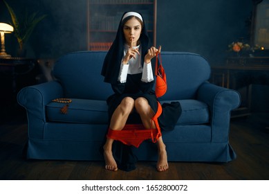 Sexy nun in cassock sitting with her panties down