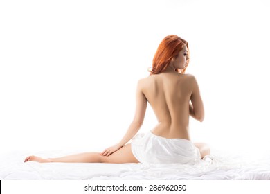 Sexy redhead woman with a naked back isolated on white