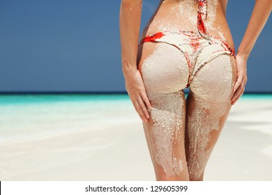 Sexy Sandy Woman Buttocks On The Beach Background