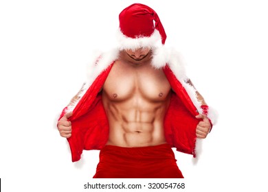 Sexy Santa Claus . Young muscular man wearing Santa Claus  hat demonstrate his muscles. Isolated on white background.