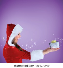 Sexy santa girl holding gift against purple vignette - Shutterstock ID 214972999