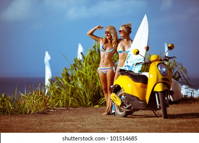 Sexy smiling surf girls near the ocean in Bali