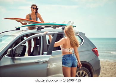 Sexy Smiling Surfer Girls By A Car Getting Ready For Surfing
