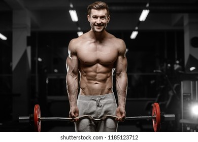sexy strong bodybuilder athletic fitness man pumping up abs muscle workout bodybuilding concept background - muscular bodybuilder handsome men doing fitness health care exercises in gym naked torso - Shutterstock ID 1185123712