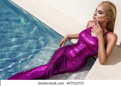 Sexy tanned model in elegant dress in pool. Stylish woman in luxury Cannes France. Summer fashion model. Bikini model.