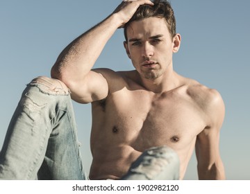 Sexy Topless Handsome Male Model Posing Against Blue Sky.