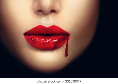 Sexy Vampire Woman lips with dripping blood. Fashion Glamour Halloween art design. Closeup of glamourous girl vampire mouth