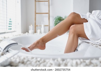 Sexy Woman In Bathrobe Wets Her Feet In The Bath