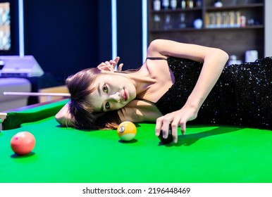 A Sexy Woman In A Black Halter Dress At A Pool Table