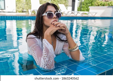 Sexy Woman   With Boho Accsessorises Posing In Pool. White Outfit. 