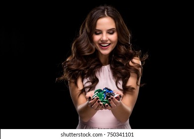 Sexy Woman In A Chic Gently Pink Dress Holding Colored Poker Chips. Woman Winning