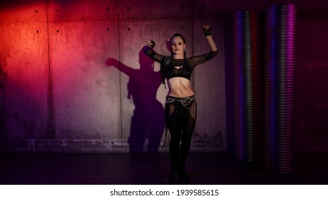 sexy woman is dancing modern choreography, using movements from belly dance, vogue and electro dance
