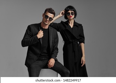 A Sexy Woman With Glasses And A Black Wig Leaned On Her Shoulder To A Brutal Young Man