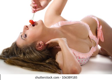 Sexy woman holding a tasty cherries on white background