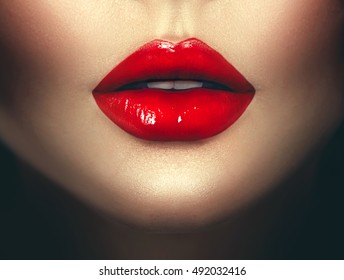 Sexy Woman lips with red lipstick. Fashion Glamour art design. Closeup of glamourous girl  mouth close-up on dark background. Passion