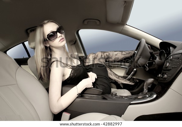 Sexy woman in a luxury
car