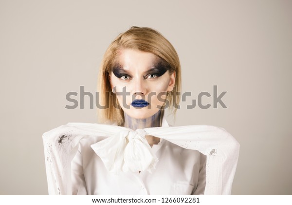 Sexy\
woman with makeup in doctor straitjacket. Beauty salon and\
hairdresser. Sexy girl with fashion makeup. Happy halloween. Makeup\
cosmetics and skincare. Bloody and horror\
halloween.