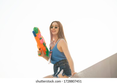 Sexy Woman On Blue Tank Top Vest Shirt With Watergun. Songkran Festival In Bangkok, Thailand.