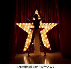 Sexy Woman On Stage.Red Velvet Curtain With Brodway Star On Background 