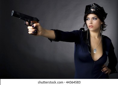Sexy woman with police uniform in studio  on dark gradient background