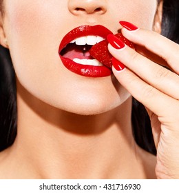 Sexy Woman With Red Lips And Nails Bite Fresh Strawberry, Closeup