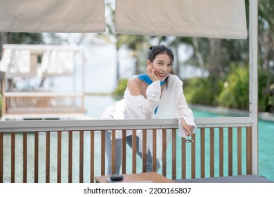 Sexy Woman Relaxing Near Sunbed Cabana By The Pool At Hotel Resort.