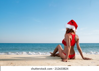 Sexy Woman In Santa Hat On Sea Beach