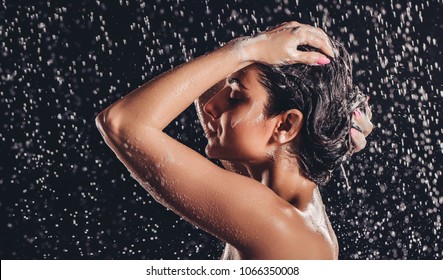 Sexy Woman In Shower. Attractive Young Naked Woman Under Water Drops Isolated On Black Background.