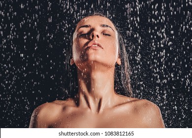 Sexy Woman In Shower. Attractive Young Naked Woman Under Water Drops Isolated On Black Background.
