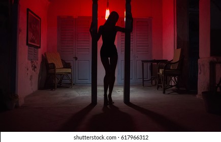 Sexy Woman Silhouette Dancing at the Hotel. Pole Dancer female Stripper in the Night Sensual Red light, noir style. Beautiful Dancing Girl with Sexy Body. Romantic Hot Erotic Private dance, striptease