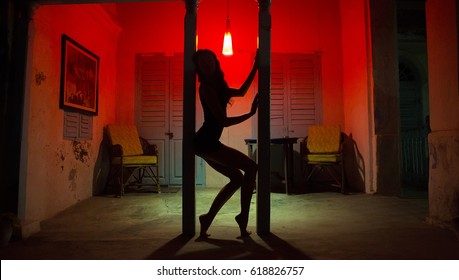 Sexy Woman Silhouette Dancing at the Hotel. Pole Dancer female Stripper in the Night Sensual Red light, noir style. Beautiful Dancing Girl with Sexy Body. Romantic Hot Erotic Private dance, striptease