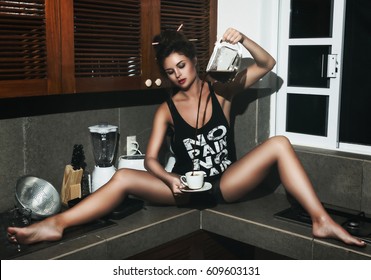 sexy-woman-sitting-on-table-260nw-609603131.jpg