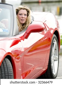 Sexy Woman Smiling Driving Hot Red Convertible Sports Car