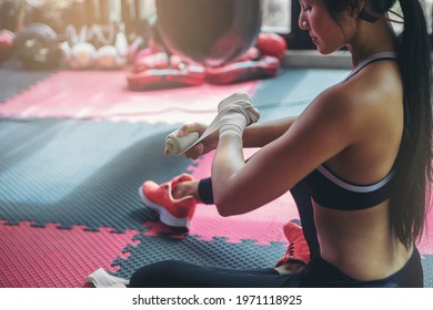 Sexy Woman Tying Tape Around Her Hand Before Get Boxing Gloves Preparing To Boxing Practice.