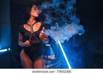 Sexy woman vaping electronic hookah. Vape concept