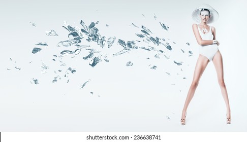 sexy woman in white hat with broken glass in studio