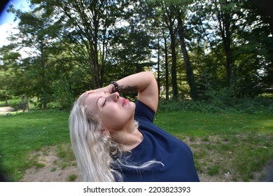 Sexy Young Blonde Woman Self Shoot In The Park Green Autumn Wearing Minidress Face Close Ups Trees