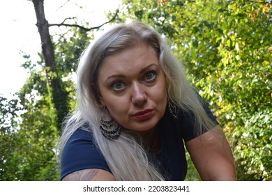 Sexy Young Blonde Woman Self Shoot In The Park Green Autumn Wearing Minidress Face Close Ups Trees