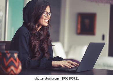 Sexy young smart hacker woman in hoodie have fun at laptop