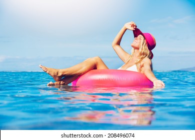 Sexy young woman in bikini relaxing floating in the ocean