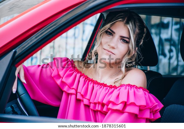 sexy young woman in car. luxury car. pretty girl\
sitting in car. fashion and style. Stylish woman in a pink dress\
sitting in a modern car