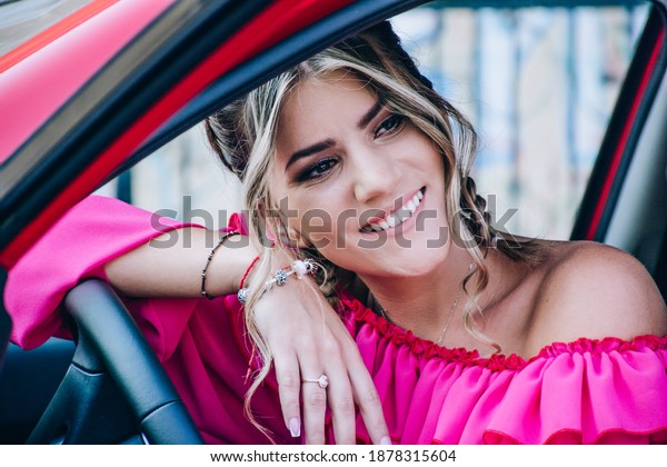sexy young woman in car. luxury car. pretty girl
sitting in car. fashion and style. Stylish woman in a pink dress
sitting in a modern car
