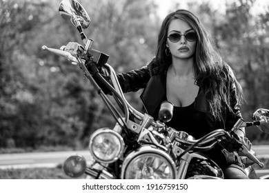 Sexy young woman on motorcycle, closeup shot, black and white image 