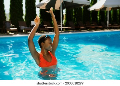 Sexy young woman swims in the pool outdoors