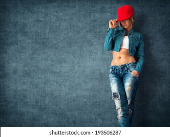 Sexy young woman in a trendy clothes on a grunge background
